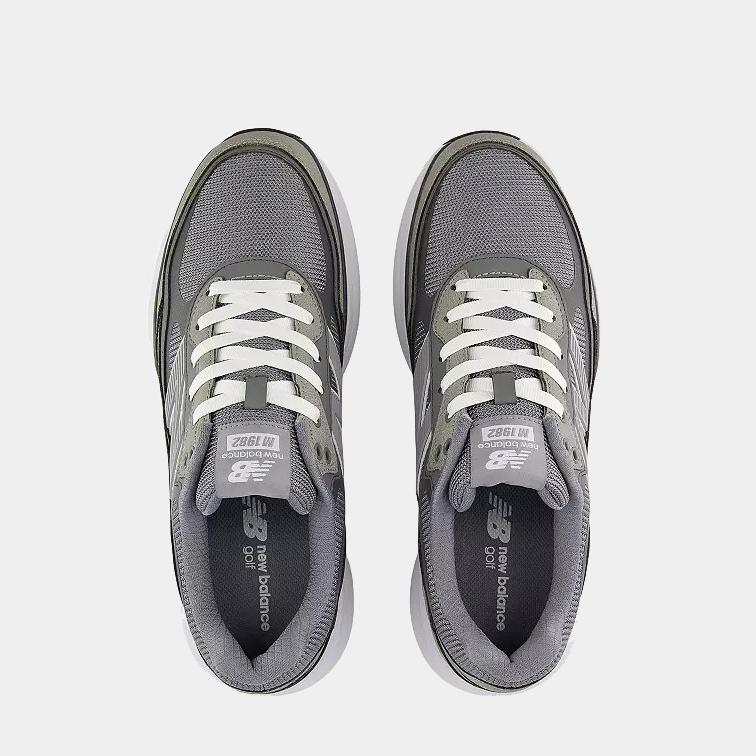 New Balance Golf 1982 Golf shoes in gray with white laces and mesh upper, top view showing tongue branding and cushioned collar.