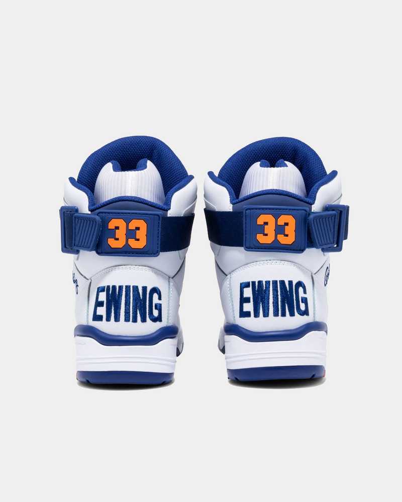 Ewing Athletics 33 HI OG sneakers in white and blue with orange "33" detailing and embroidered "EWING" text on the heel, back view.