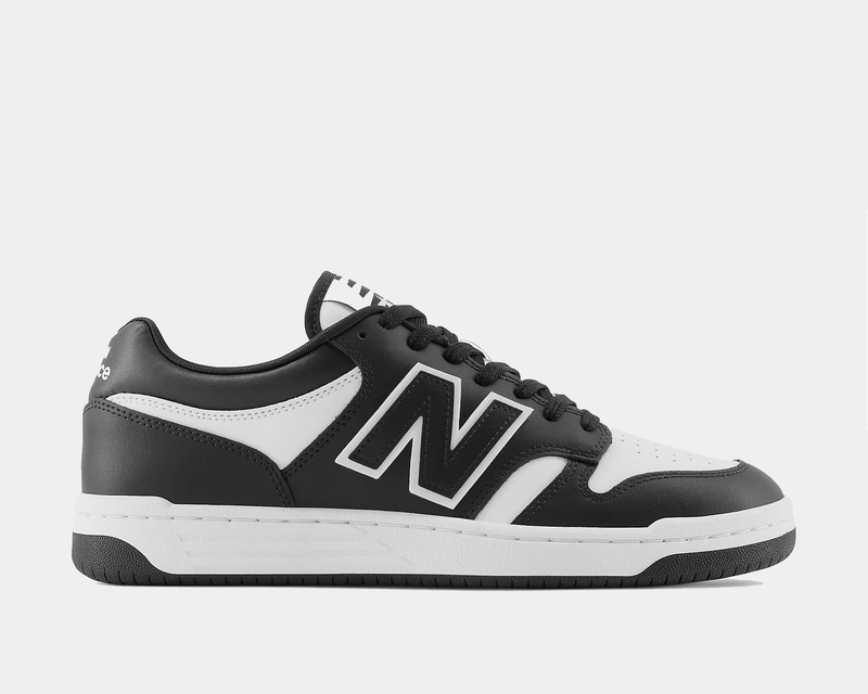 New Balance 480 sneakers in black and white leather with signature "N" logo, side view.