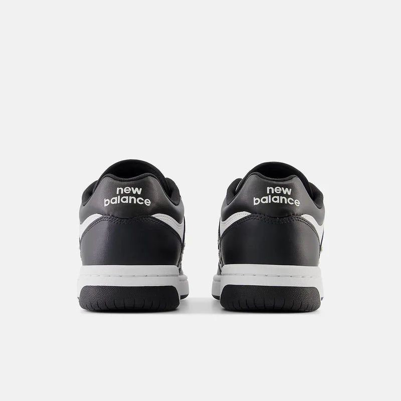 New Balance 480 sneakers in black and white, back view showing logo on heel tab and cushioned sole.