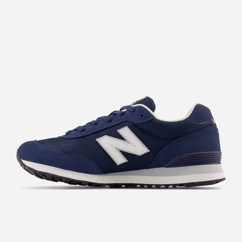 New Balance 515 v3 sneakers in navy blue with white logo, suede and mesh upper, cushioned midsole, and rubber outsole, side view.