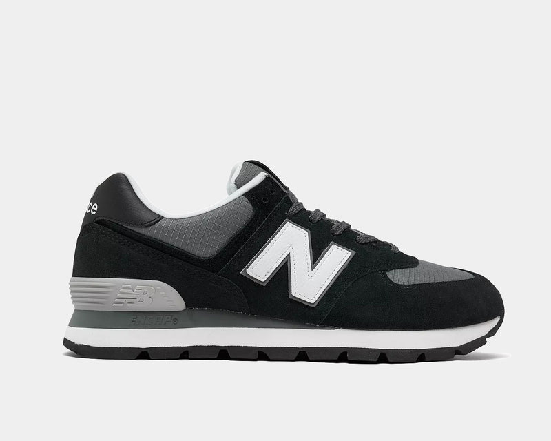 New Balance 574 Rugged shoes in black and gray with suede overlays, mesh panels, ENCAP midsole, and rugged outsole, side view.