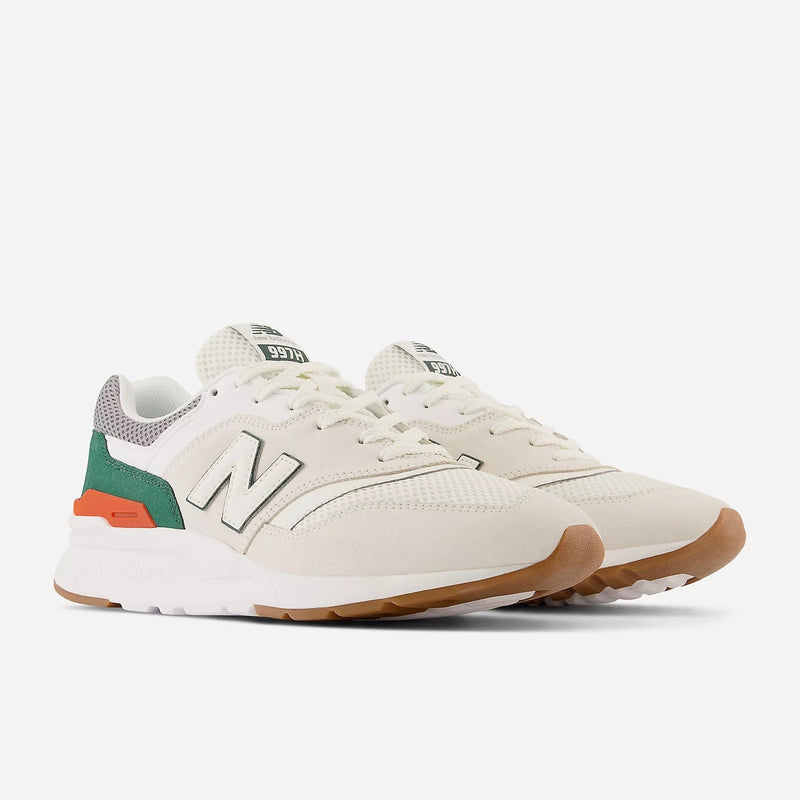 New Balance 997H sneakers in cream with green and orange accents, white midsole, and gum outsole, front angled view.