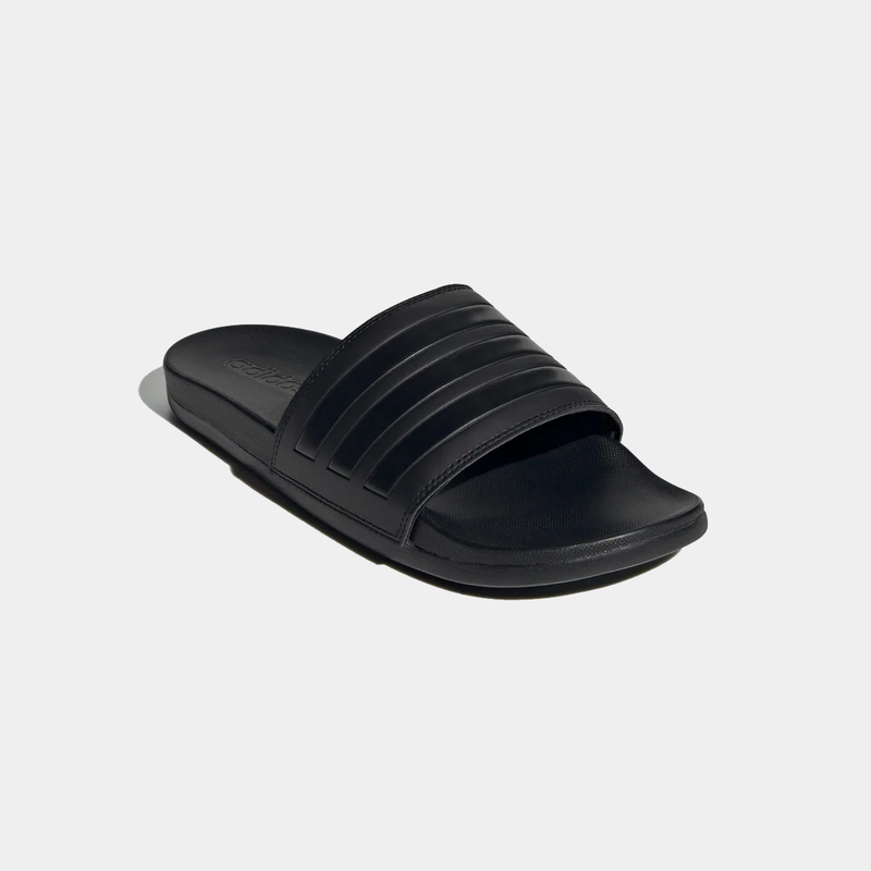 Adidas Adilette Comfort Slides in black with textured single-strap upper and cushioned footbed, angled side view.