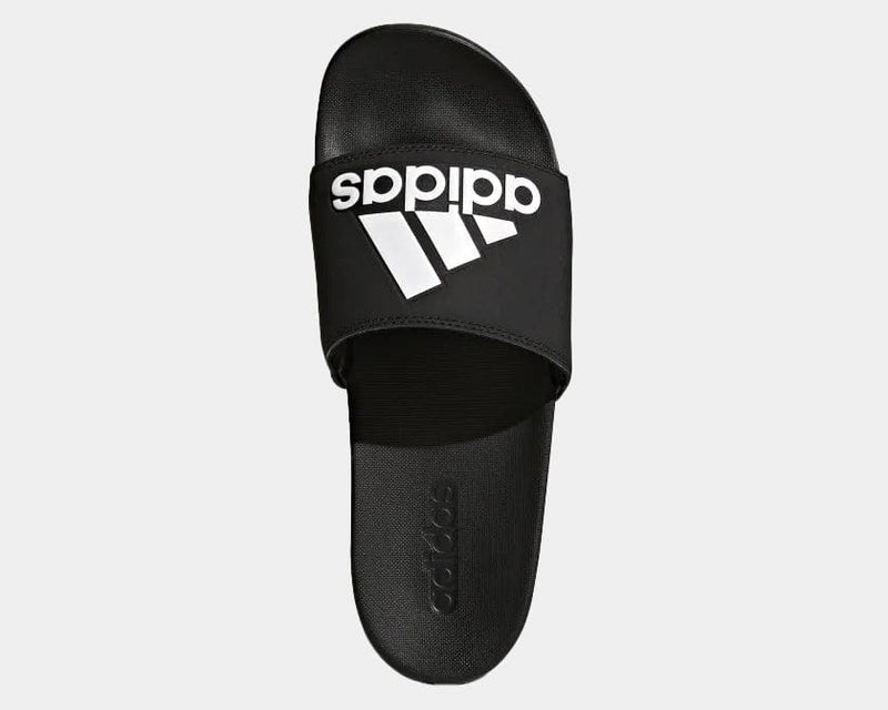 Adidas Adilette Comfort Slides in black with white logo on strap and textured footbed, top view.