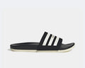 Adidas Adilette Comfort slides in black with white stripe detail and contoured footbed, side view.