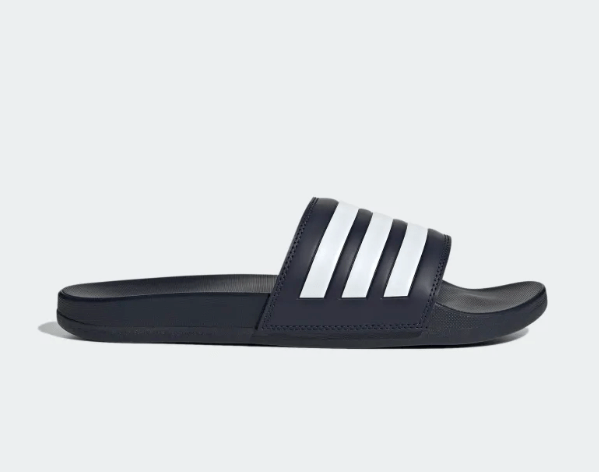 Adidas Adilette Comfort slides in navy blue with white signature three-stripe design, side view.