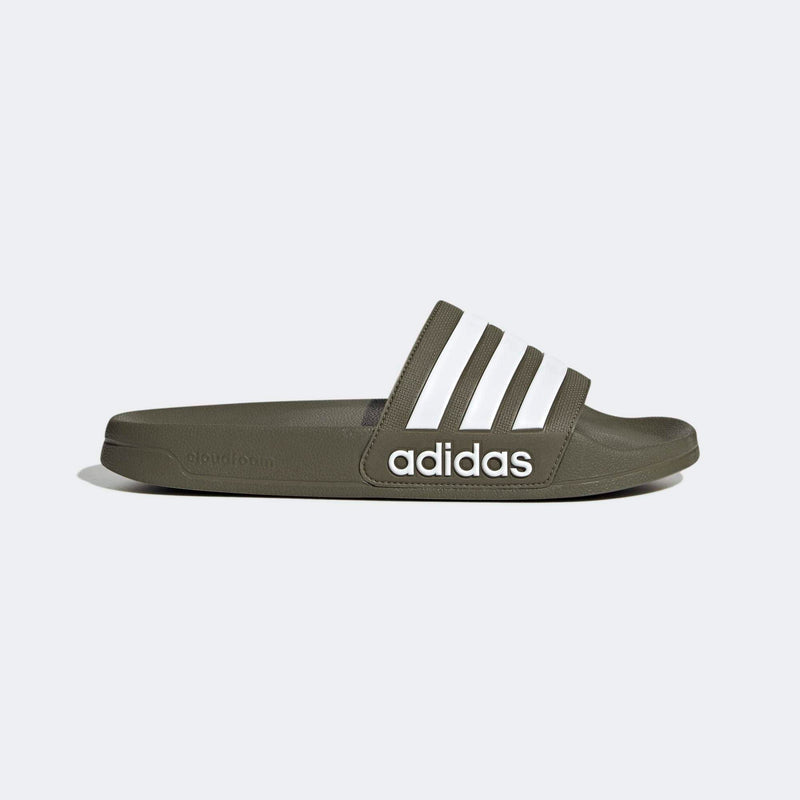 Adidas Adilette Comfort slides in olive green with white stripes and Cloudfoam cushioning, side view.