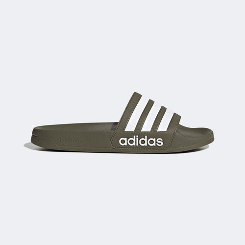 Adidas Adilette Comfort slides in olive green with white stripes and Cloudfoam cushioning, side view.
