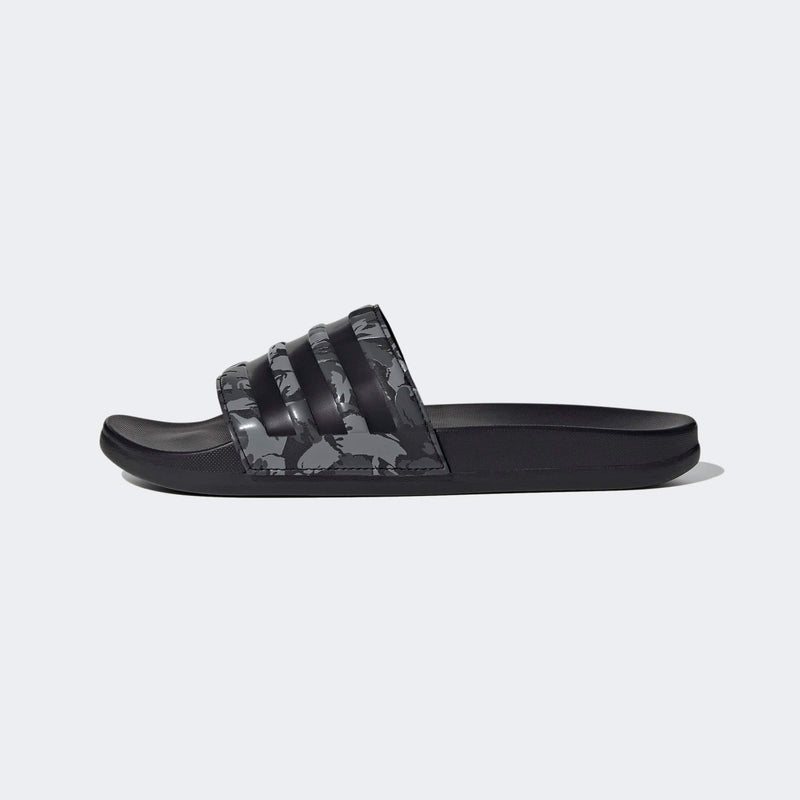 Adidas Adilette Comfort slide sandals in black with a camouflage print strap, lightweight design, side view.