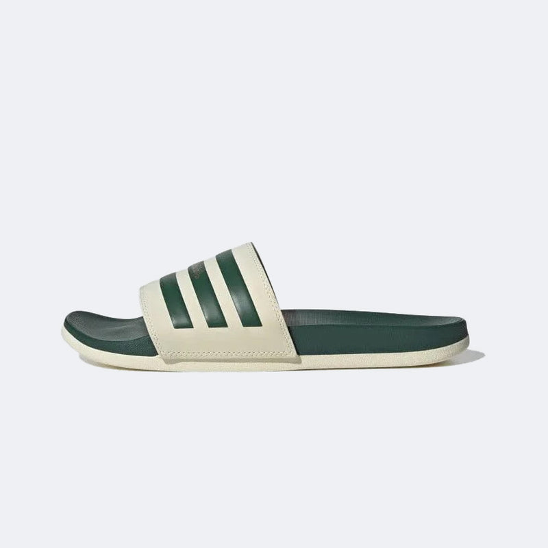 Adidas Adilette Comfort sandals in green and beige with a contoured footbed and striped band, side view.