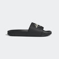 Adidas Adilette Shower Slides in black with white logo and Cloudfoam footbed, side view.