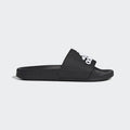 Adidas Adilette Shower Slides in black with a white logo and synthetic strap, side view