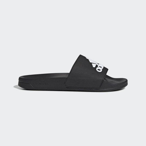 Adidas Adilette Shower Slides in black with a white logo and synthetic strap, side view