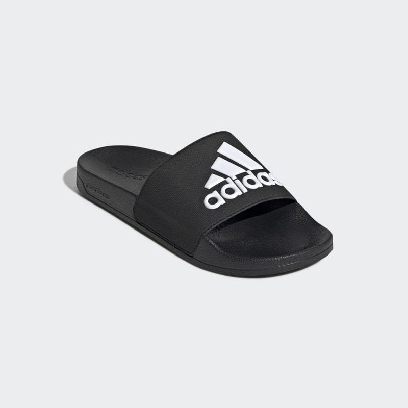 Adidas Adilette Shower Slides in black with bold white logo on wide strap, featuring a contoured footbed, angled front view.