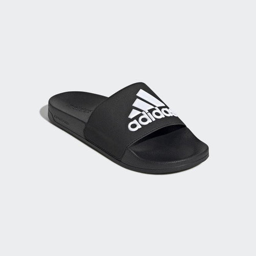 Adidas Adilette Shower Slides in black with bold white logo on wide strap, featuring a contoured footbed, angled front view.
