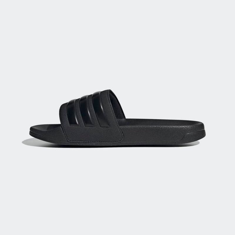 Adidas Adilette Shower Slides in black with three-stripe design and textured sole, side view.