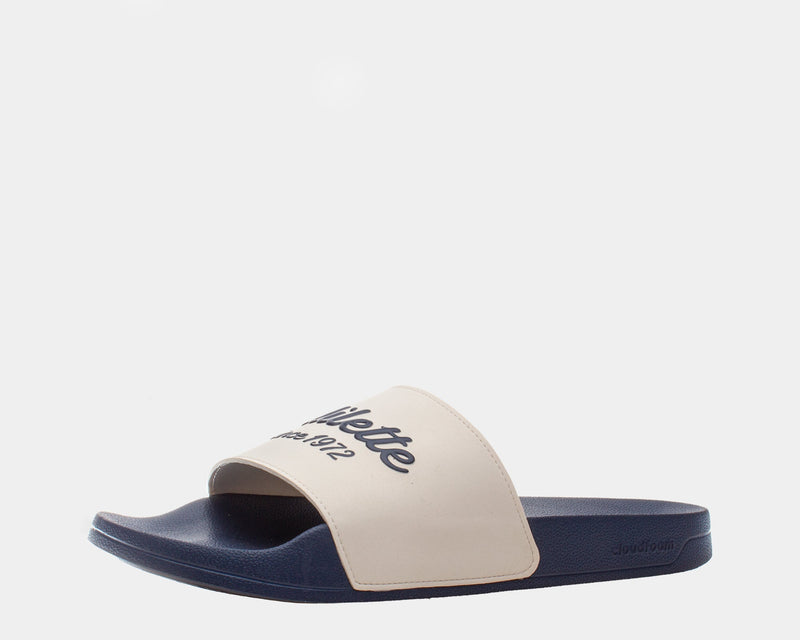 Adidas Adilette Shower Slides in beige and navy blue with a textured footbed and bold logo on strap, side view