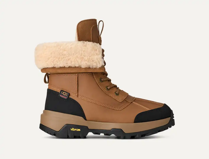 UGG Adirondack Boot XXV in chestnut brown with sheepskin collar, waterproof leather, and Vibram outsole, side view.