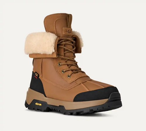 UGG Adirondack Boot XXV winter boots in chestnut brown with waterproof leather, wool lining, and Vibram outsole, front-side view.