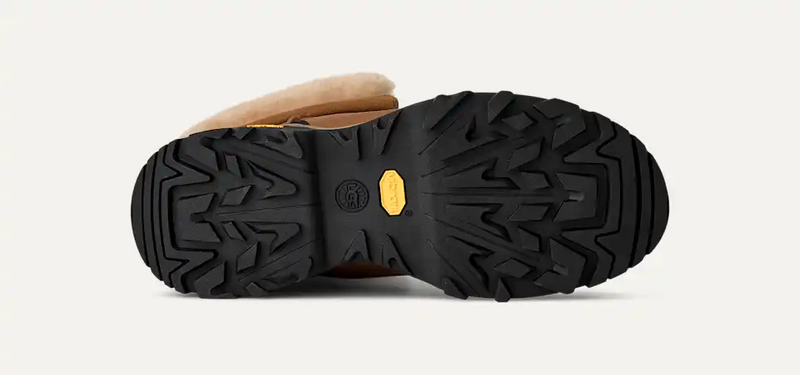UGG Adirondack Boot XXV outsole with black rubber tread and yellow Vibram logo, sole view showing durable traction pattern.