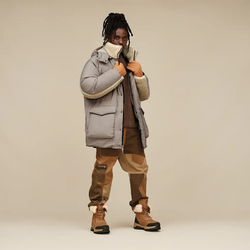 UGG Adirondack Boot XXV in tan with shearling lining, waterproof leather upper, and durable rubber outsole, lifestyle context.