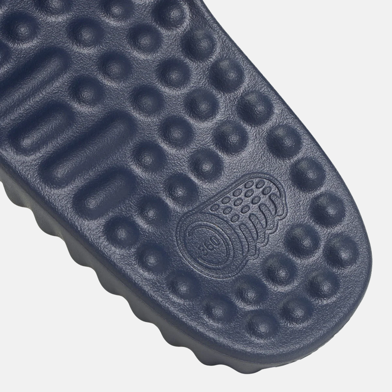 Adidas Adissage 360REC Slides navy blue footbed with textured massage nubs and embossed branding, close-up view.