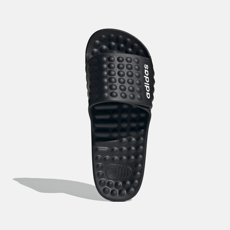 Adidas Adissage 360REC slides in black featuring contoured footbed with textured massage nubs and branded strap, top view.