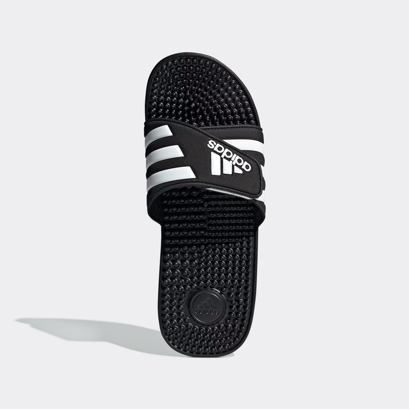 Adidas Adissage Slide sandals in black with white stripes, featuring a textured massaging footbed, top view.