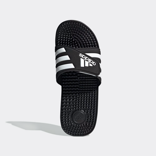 Adidas Adissage Slide sandals in black with white stripes, featuring a textured massaging footbed, top view.