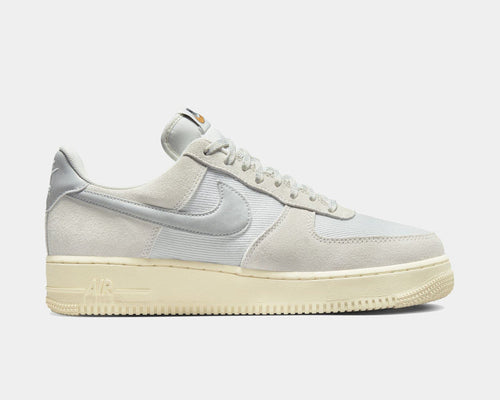 Nike Air Force 1 '07 LV8 sneakers in light gray suede and tonal canvas with signature Swoosh logo, side view.