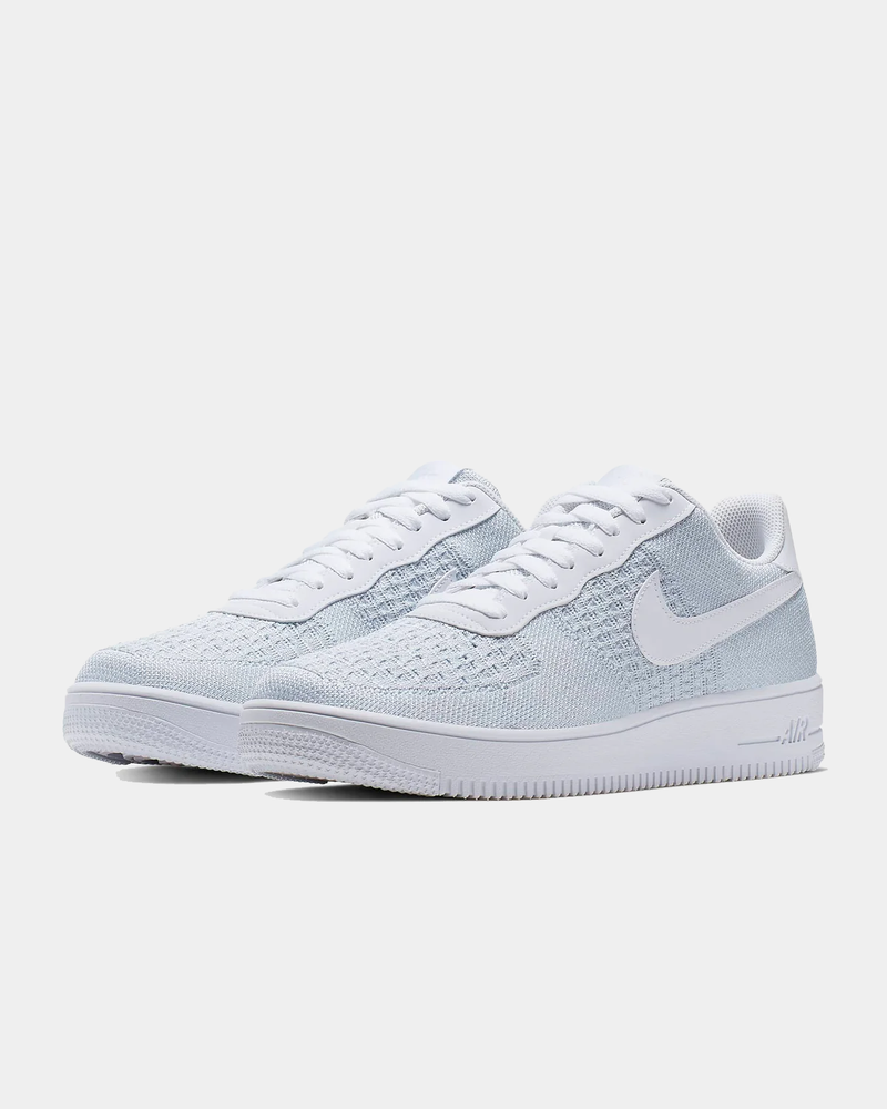 Nike Air Force 1 Flyknit 2.0 sneakers in white and light blue with lightweight Flyknit upper and classic Air sole unit, angled front view
