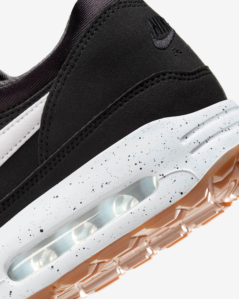 Nike Air Max 1 '86 OG Golf shoes back view showing black suede upper, speckled white midsole with visible Air Max unit, and gum outsole.