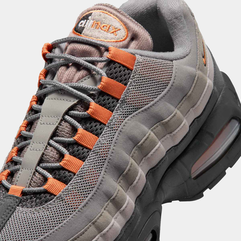 Nike Air Max 95 Big Bubble "OG" sneakers in gray with orange accents, featuring mesh upper and visible air units, angled view.