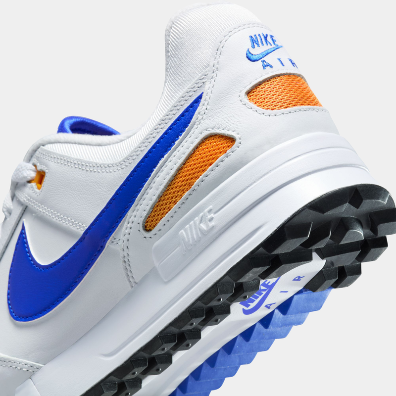 Nike Air Pegasus 89' G sneakers with a white leather upper, blue Swoosh, orange mesh detailing, and textured outsole, angled back view.
