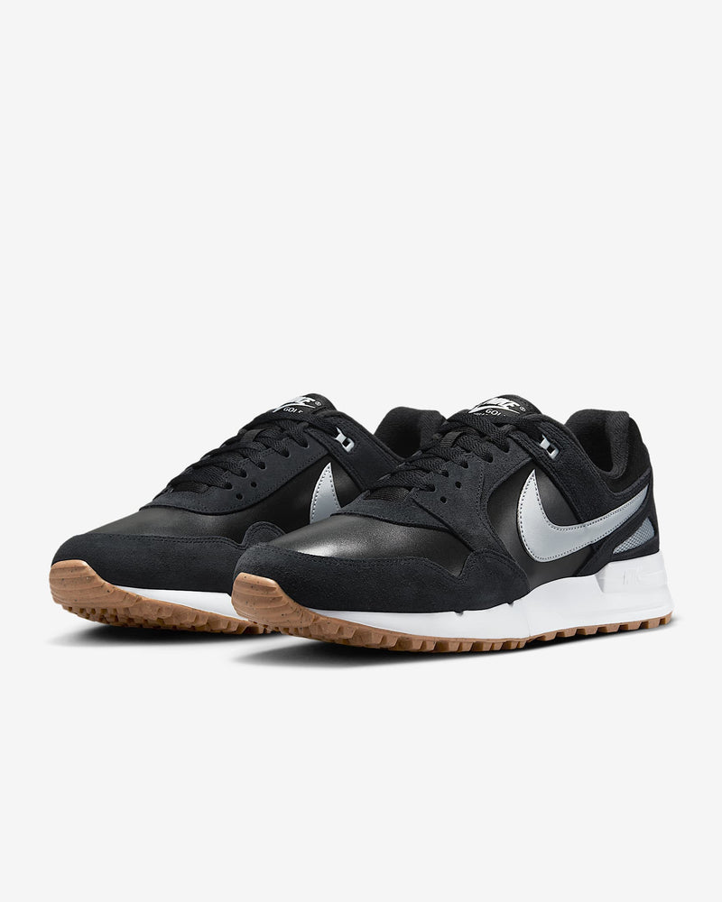 Nike Air Pegasus 89' G sneakers in black with silver Swoosh logo, fabric and suede upper, and gum outsole, front angle view.