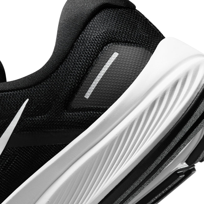 Nike Air Zoom Structure 24 running shoes, close-up of black mesh upper with reflective details and white midsole grooves.