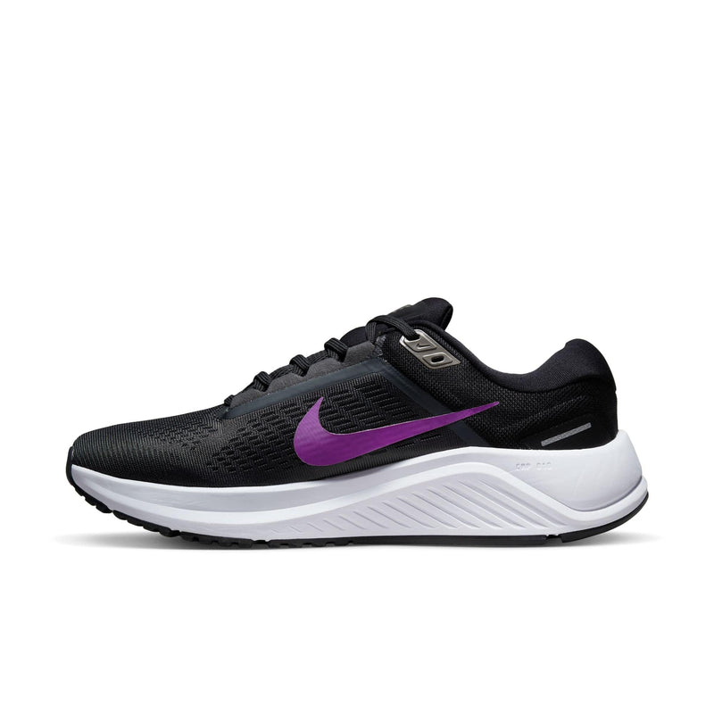 Nike Air Zoom Structure 24 running shoes in black with purple swoosh, breathable mesh upper, and cushioned white midsole, side view.