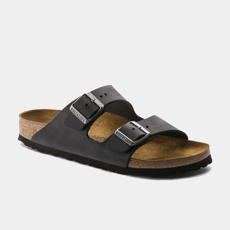Birkenstock Arizona Oiled Leather sandals in black with adjustable buckle straps and cork footbed, side angle view.