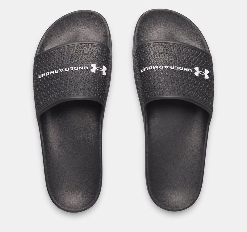 Under Armour ARMR Shower sandals in black with textured strap and logo, top view.