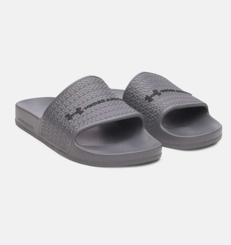 Under Armour ARMR Shower slides in gray with textured strap and logo detail, angled front view.