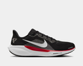 Nike Atlanta Falcons Pegasus 41 running shoes in black with mesh upper, white Swoosh logo, red midsole accents, and Falcons team logo, side view.