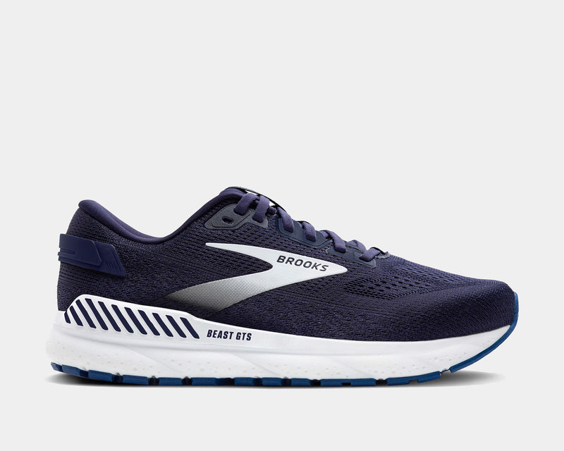 A pair of Brooks Beast GTS 24 running shoes with navy blue, white, and gray colors, featuring the Brooks logo on the side.