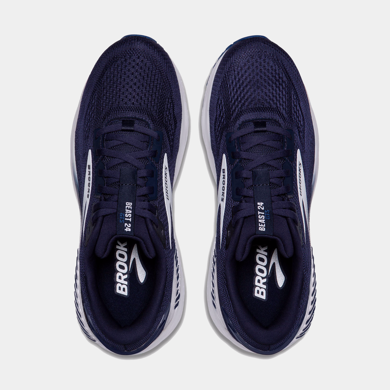 Navy running shoes with white accents on a light gray background