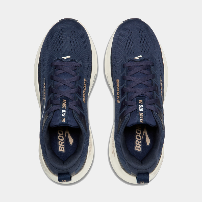 "Brooks Beast GTS 26 running shoes in navy blue with mesh upper, lace-up closure, and gold accents, top view"