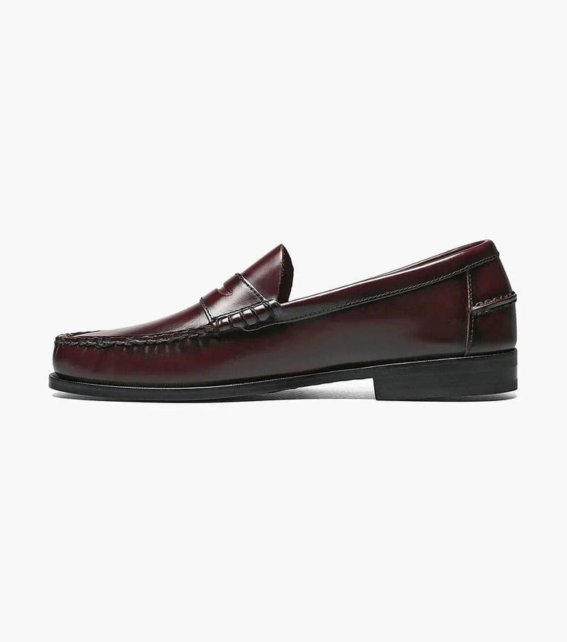 Florsheim Berkley Penny Loafer shoes in burgundy leather with moc toe stitching and penny strap detail, side view.