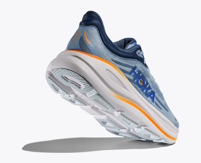 HOKA Bondi 9 running shoes in light blue with navy and orange accents, featuring a cushioned midsole and durable outsole, angled bottom view.