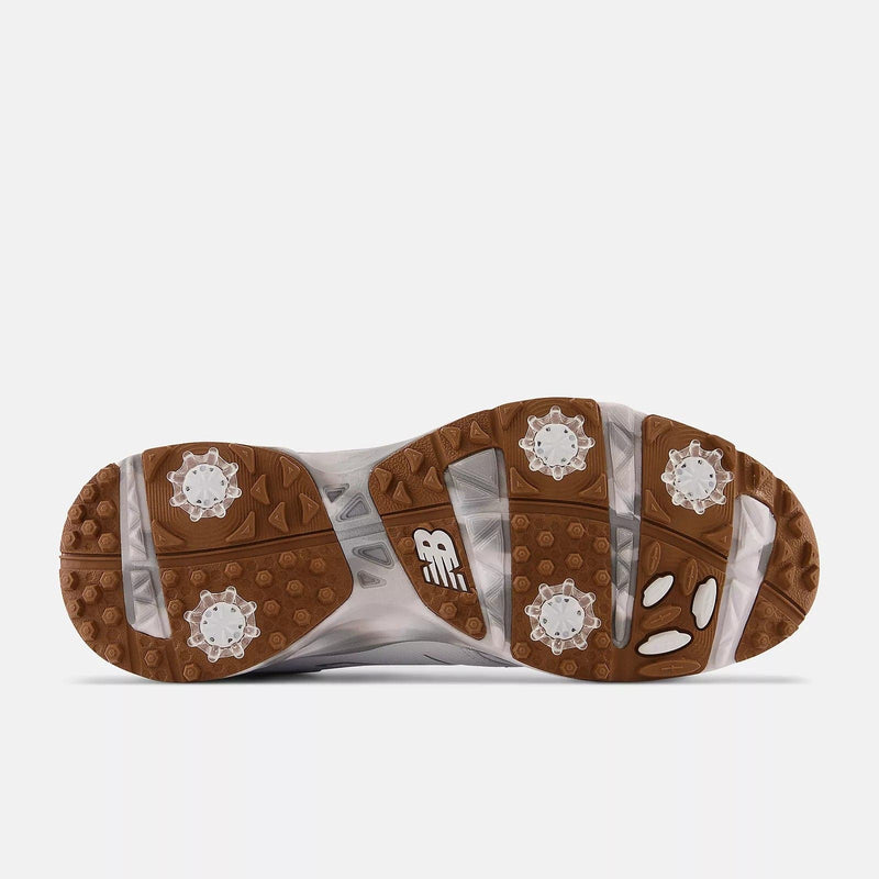 New Balance Golf Brighton Golf shoe outsole featuring durable rubber in brown and white with removable cleats for enhanced traction.