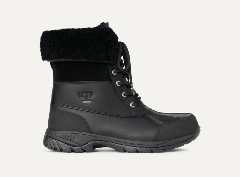 UGG Butte boots in black with waterproof leather and suede upper, lace-up design, and plush shearling collar, side view.