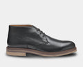 A black full-grain leather chukka boot with a crepe rubber sole and contrast edge detail.
